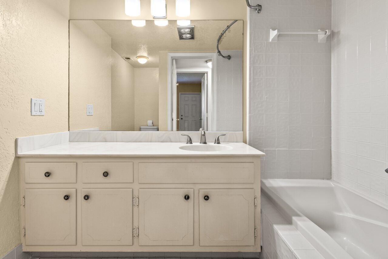 1040 Banyan Road, Unit 501C Boca Raton, FL 33432 - Photo 28 of 47 a bathroom with a bathtub shower sink vanity and mirror
