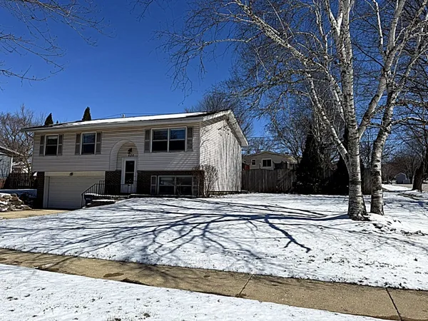 a view of a house with snow on the road