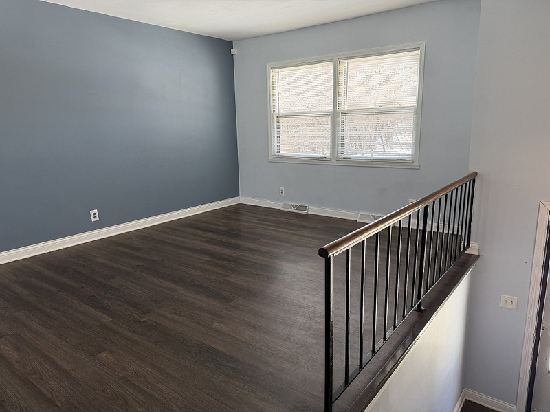 620 South 9th Avenue St. Charles, IL 60174 - Photo 3 of 30 a view of an empty room with wooden floor and a window