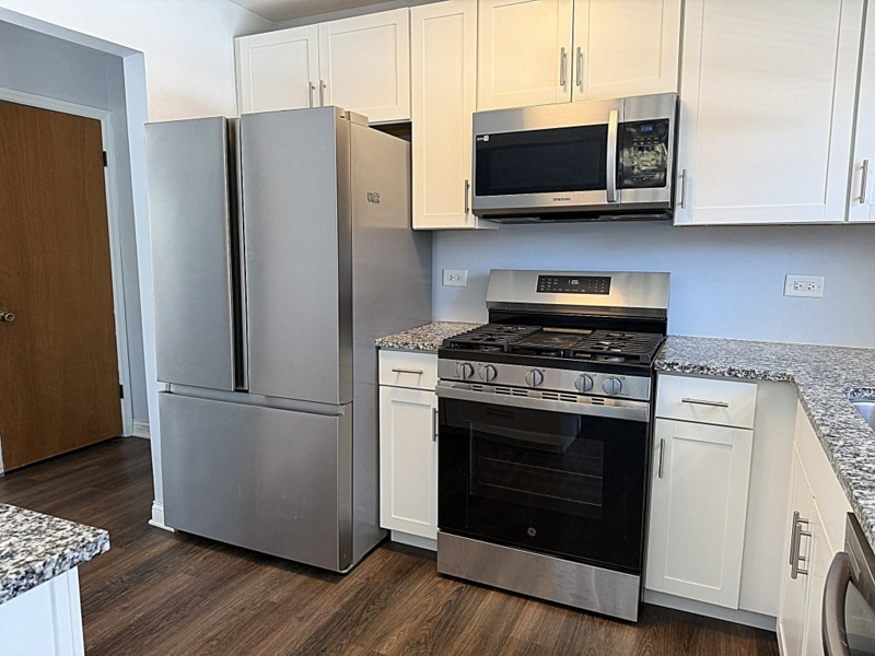 620 South 9th Avenue St. Charles, IL 60174 - Photo 10 of 30 a kitchen with stainless steel appliances white cabinets white stove a microwave and a refrigerator