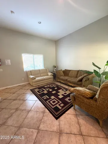 a living room with furniture rug and window