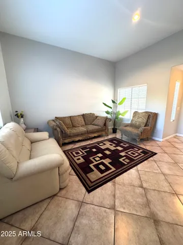 a spacious bedroom with a bed and a chandelier