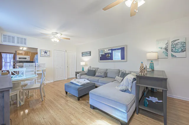 a living room with furniture a lamp and a chandelier