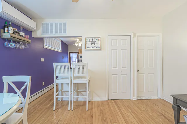 a dining room with wooden floor and chandelier