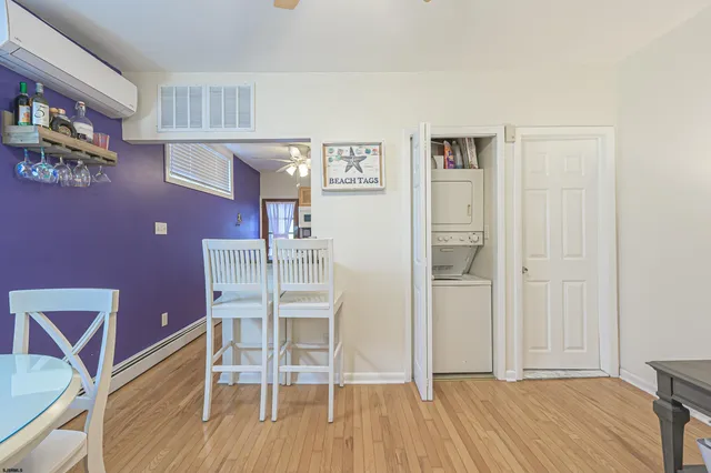 a dining room with wooden floor and chandelier