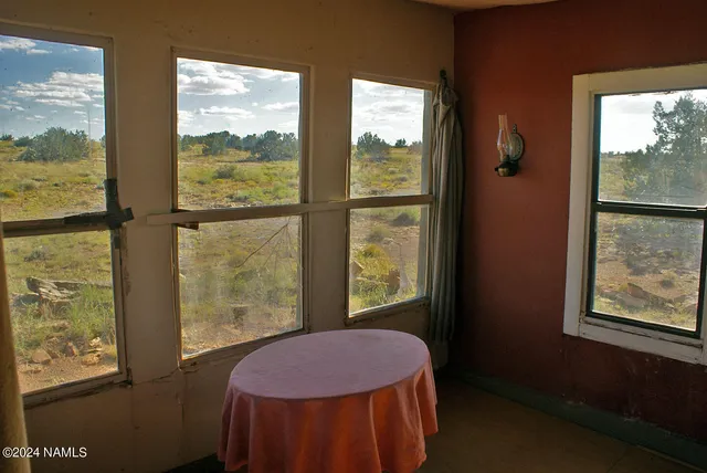 a bedroom with a bed and large window