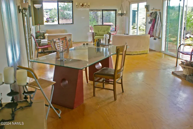 a view of a dining room with furniture and a window