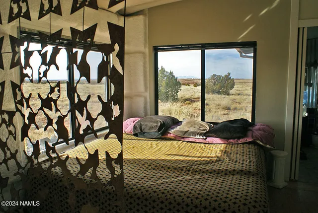 a bedroom with a bed and a window