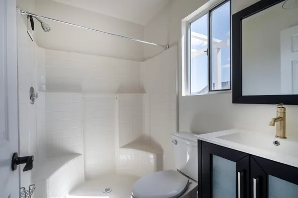 a bathroom with a sink toilet and shower