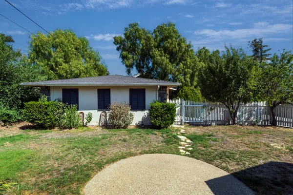 a view of a house with backyard porch and sitting area