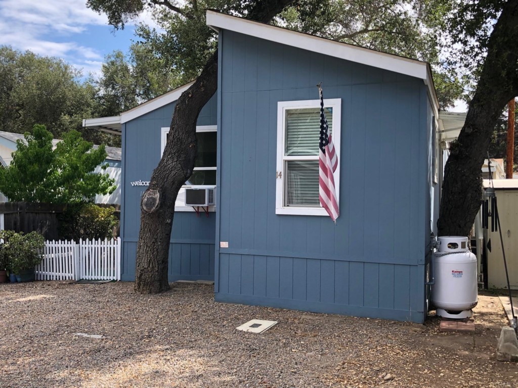 12306 Old Pomerado Road, Unit 14 Poway, CA 92064 - Photo 3 of 20 a front view of a house with garden
