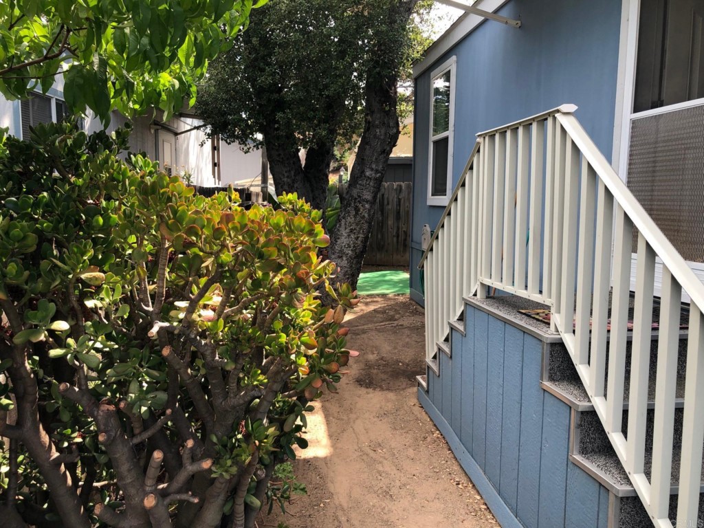 12306 Old Pomerado Road, Unit 14 Poway, CA 92064 - Photo 6 of 20 a view of a pathway of a house with wooden fence