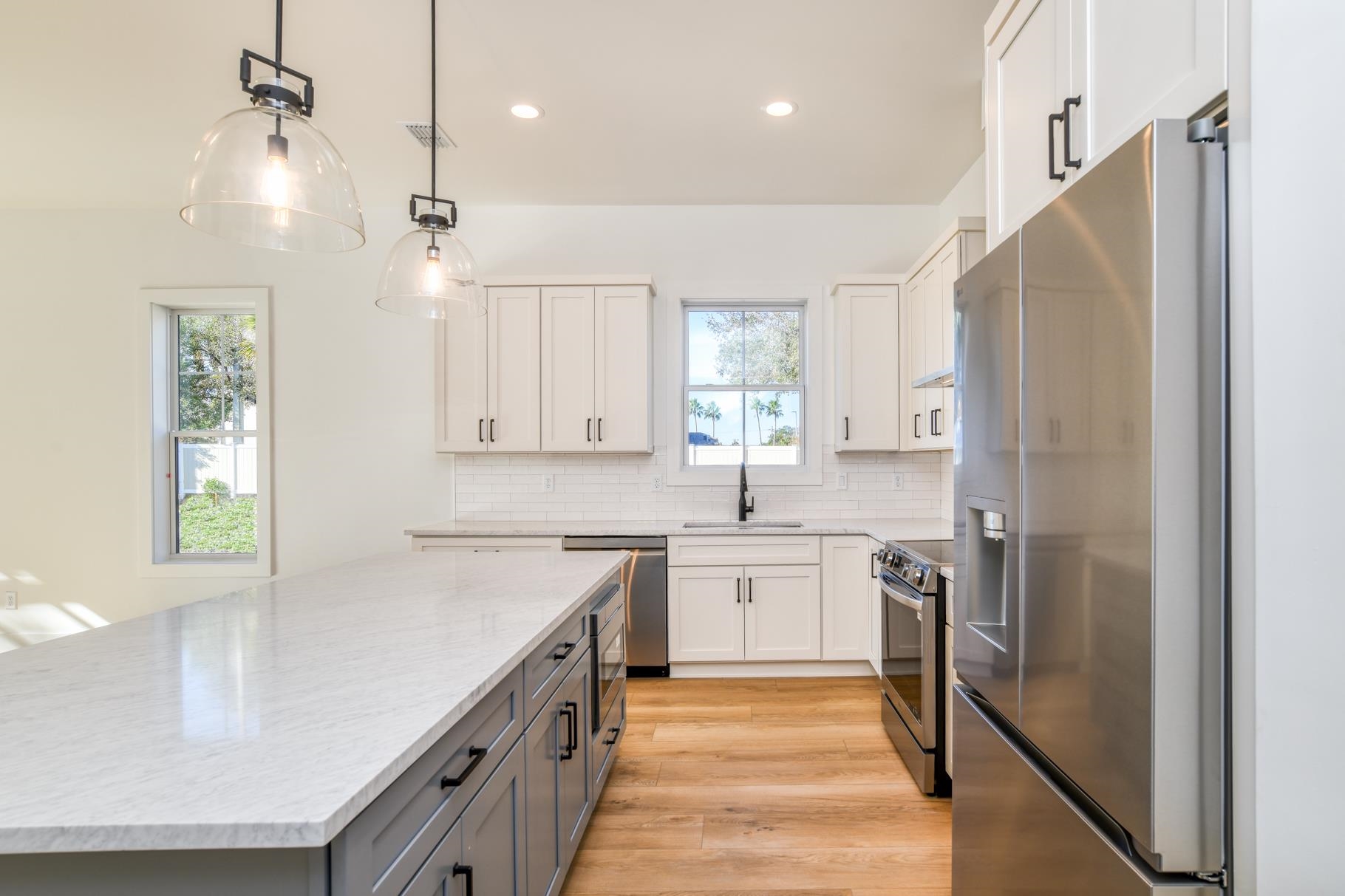 7 Sebastian Avenue, Unit C St. Augustine, FL 32084 - Photo 11 of 42 a kitchen with white cabinets and stainless steel appliances