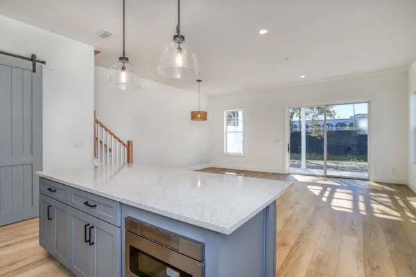 a view of a kitchen with a sink a window and appliances