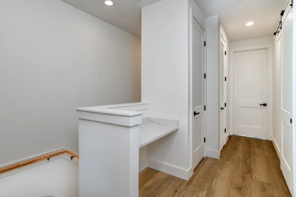 a view of hallway with wooden floor