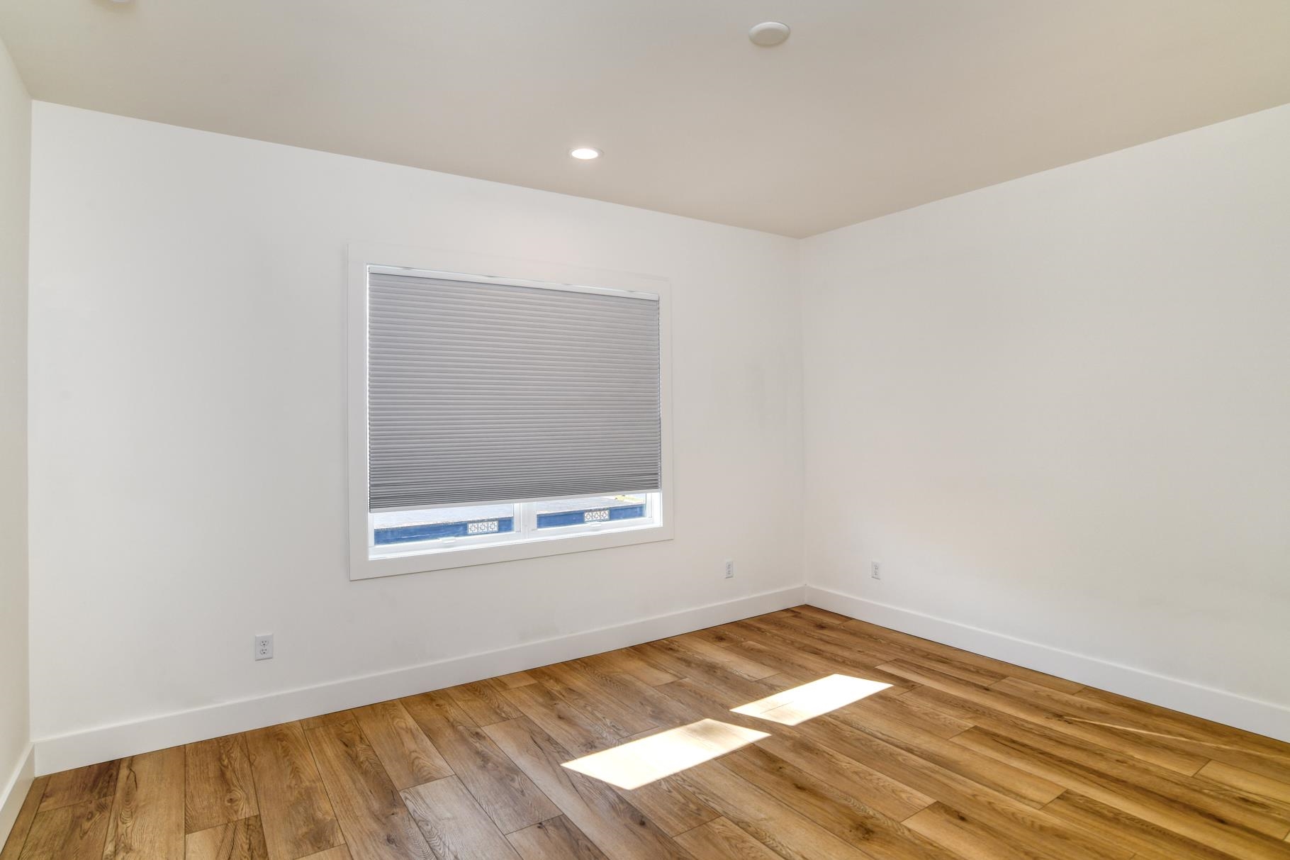 7 Sebastian Avenue, Unit C St. Augustine, FL 32084 - Photo 19 of 42 an empty room with wooden floor and windows