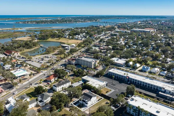 an aerial view of a city with ocean view