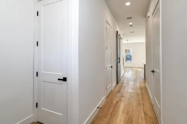 a view of a bathroom from a hallway