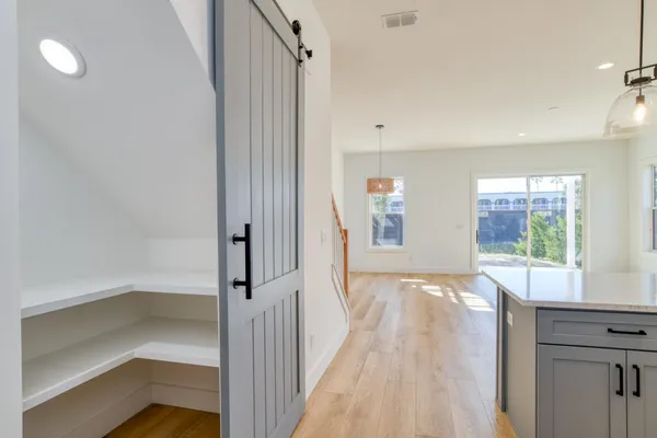 a view of a room with wooden floor and windows