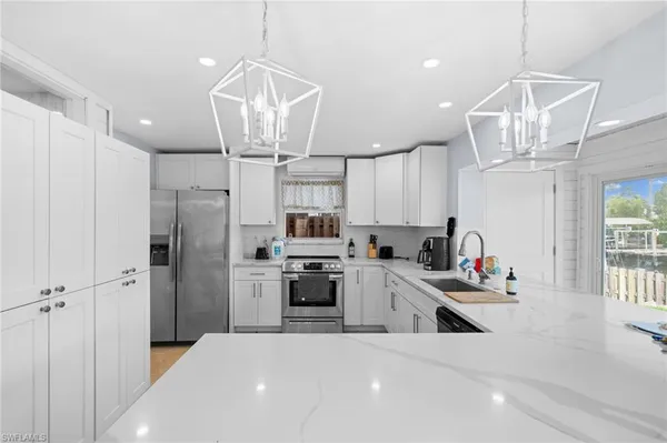 a kitchen with stainless steel appliances a refrigerator sink and cabinets