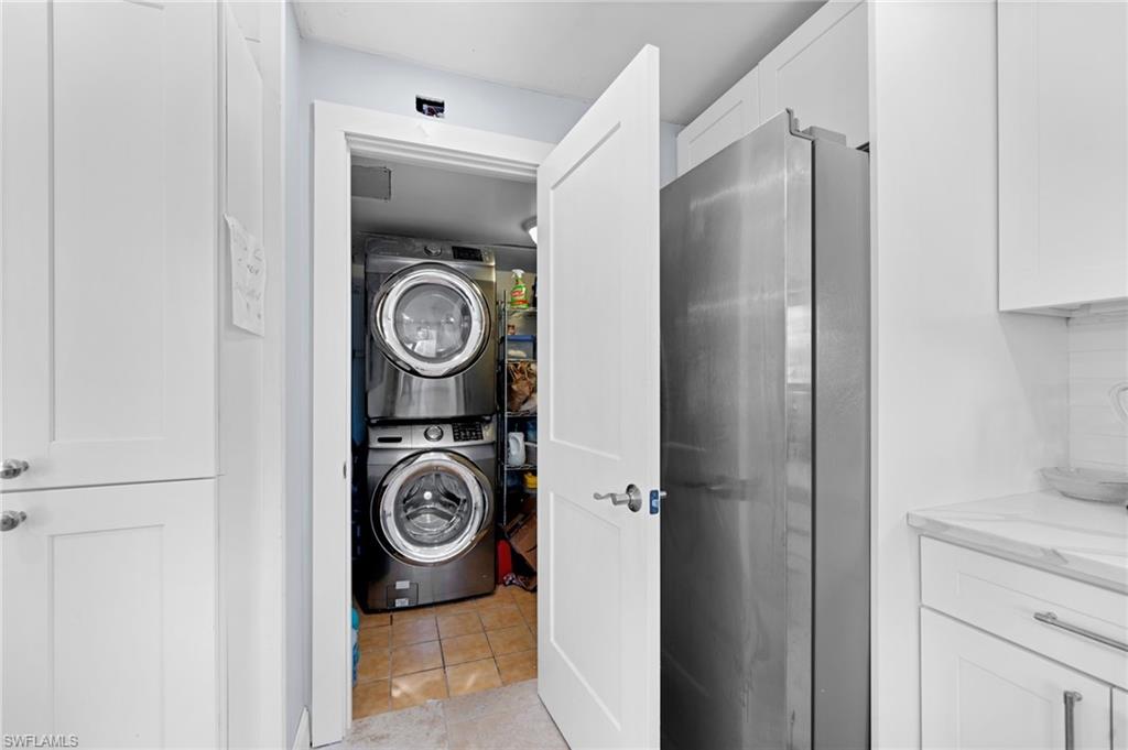 1360 Chesapeake Avenue Naples, FL 34102 - Photo 21 of 22 Washroom with stacked washer / drying machine and light tile patterned floors