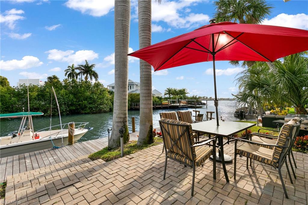 1360 Chesapeake Avenue Naples, FL 34102 - Photo 5 of 22 View of patio featuring a boat dock and a water view