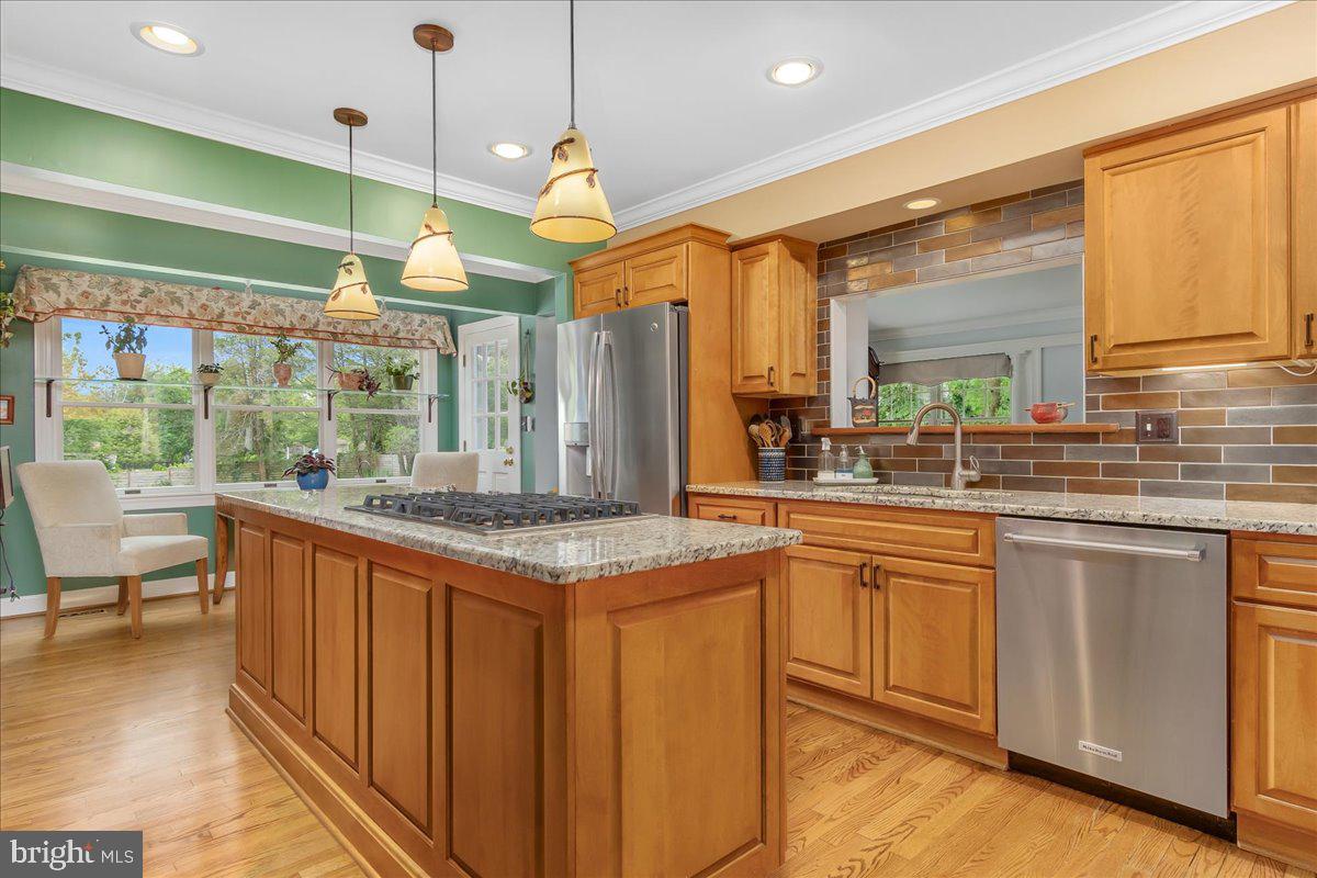 517 Valley View Road Towson, MD 21286 - Photo 41 of 89 a kitchen with stainless steel appliances granite countertop a stove a sink and a wooden cabinets
