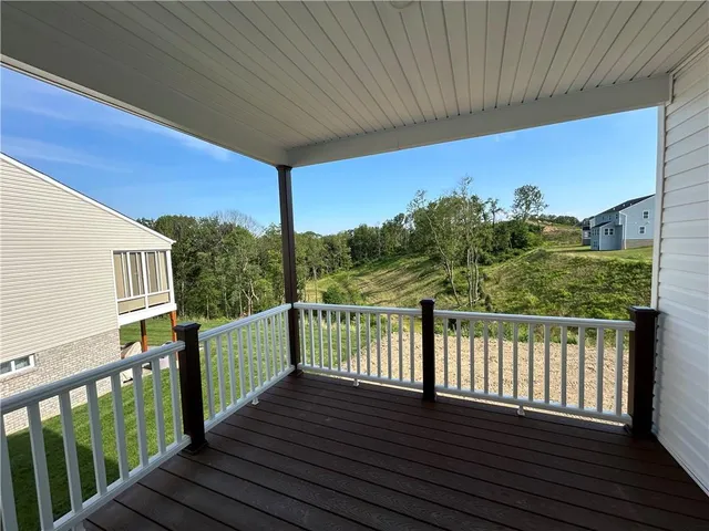 a view of a balcony with wooden floor