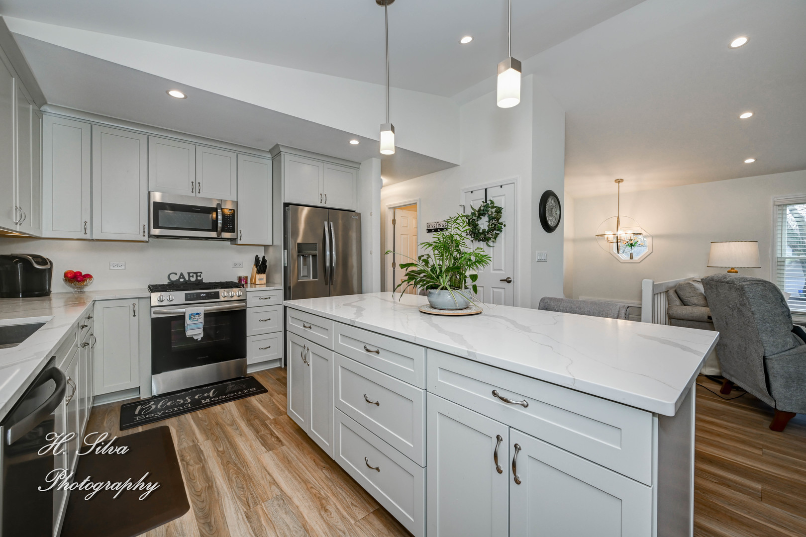 1109 Needham Road Naperville, IL 60563 - Photo 5 of 16 a kitchen with kitchen island white cabinets and stainless steel appliances