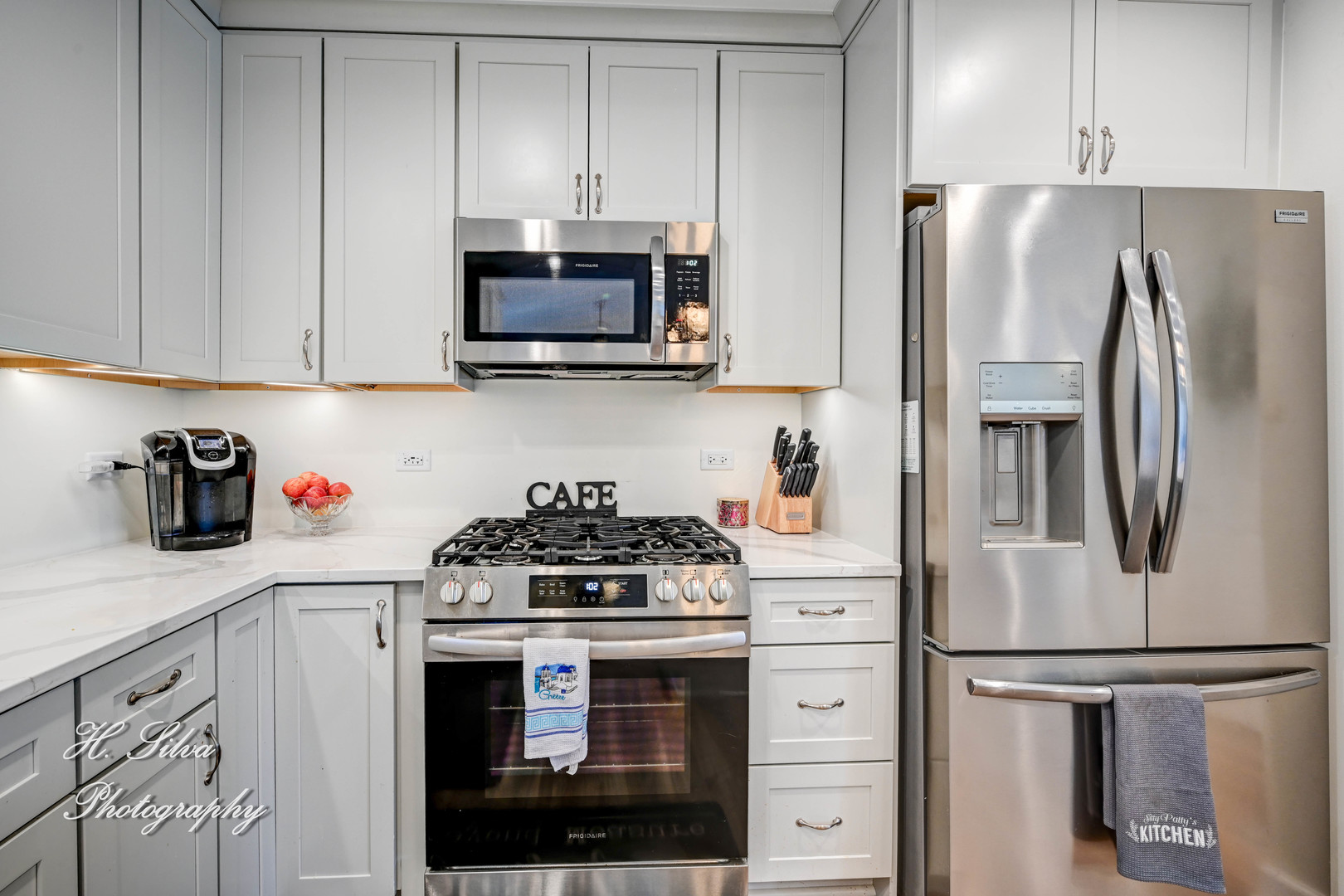 1109 Needham Road Naperville, IL 60563 - Photo 6 of 16 a kitchen with white cabinets and stainless steel appliances