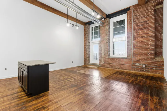 a living room with fireplace furniture and a wooden floor