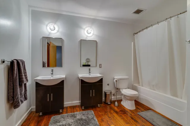 a view of a swimming pool with a lounge chairs in front of a house