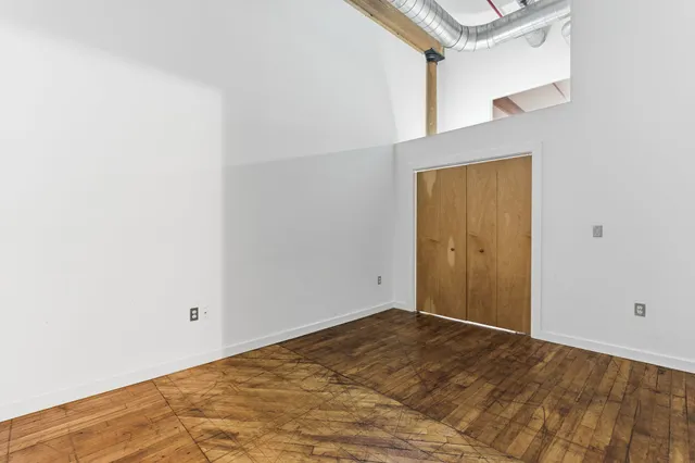 a street view with tall buildings and a park