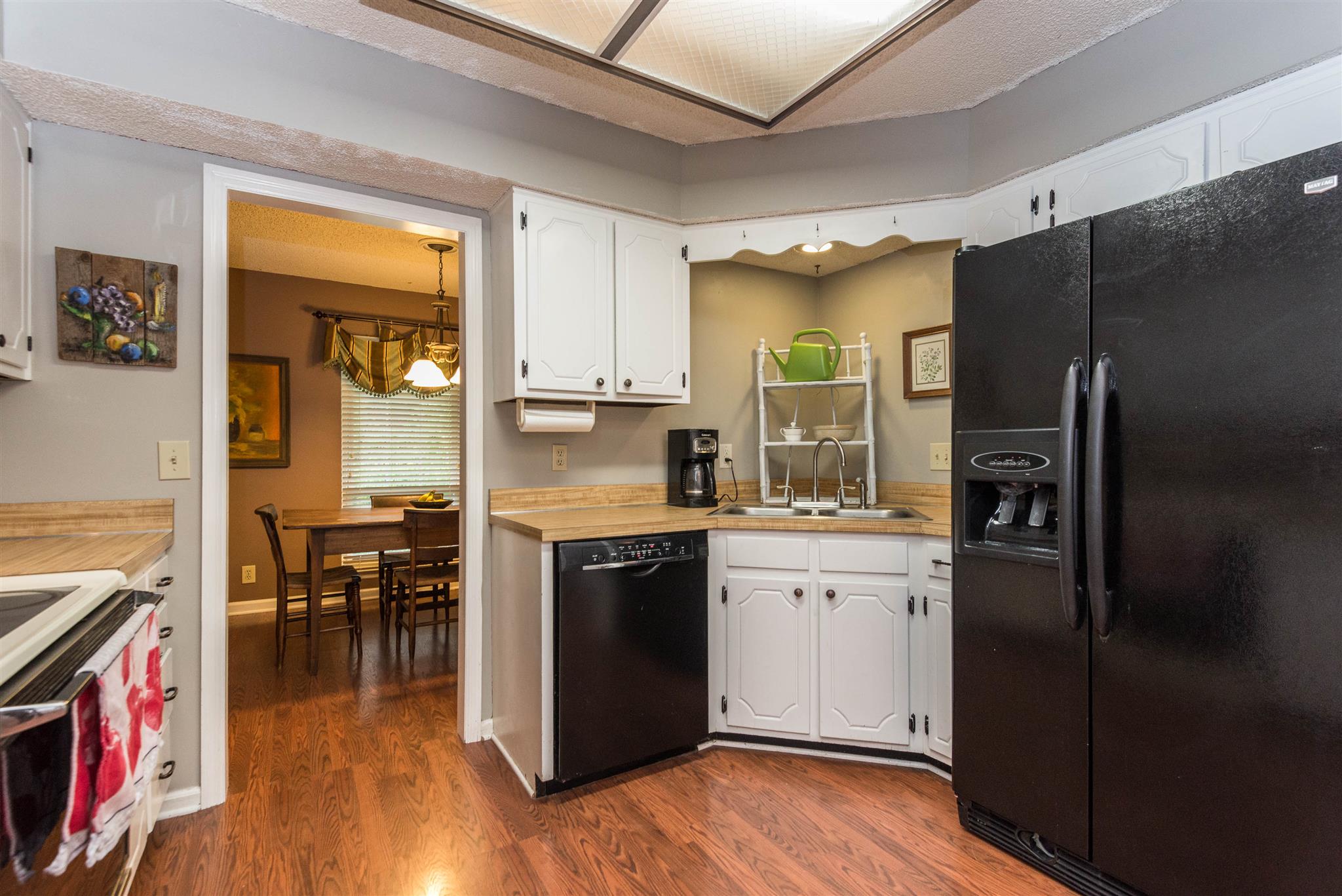 316 Cedarcliff Road Antioch, TN 37013 - Photo 14 of 27 a kitchen with stainless steel appliances granite countertop a refrigerator a stove and a wooden floors
