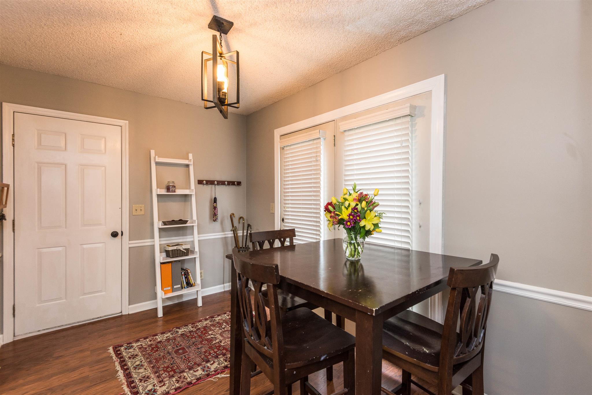 316 Cedarcliff Road Antioch, TN 37013 - Photo 19 of 27 a dining room with furniture potted plants and wooden floor