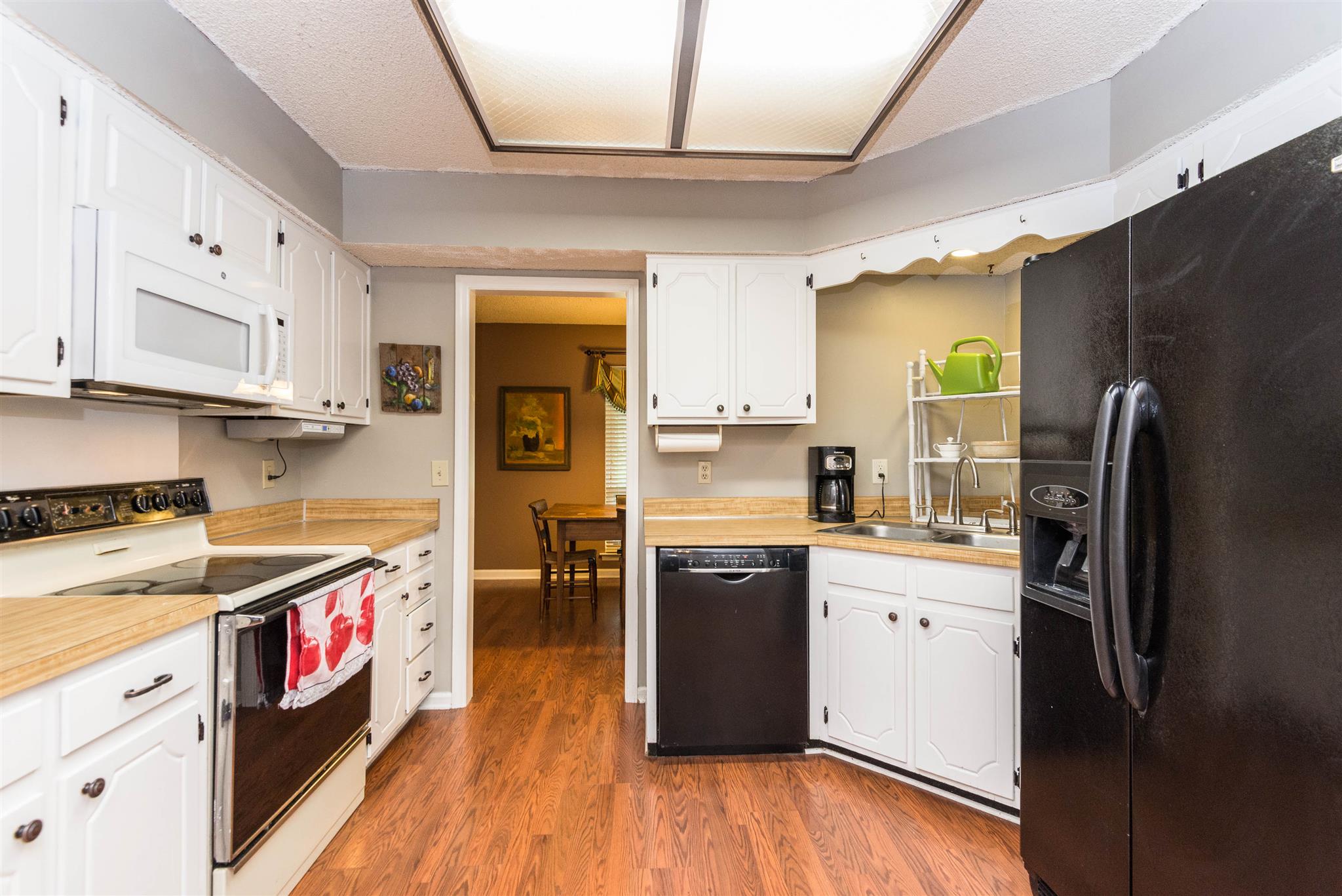 316 Cedarcliff Road Antioch, TN 37013 - Photo 21 of 27 a kitchen with stainless steel appliances granite countertop a refrigerator a stove and a wooden floors