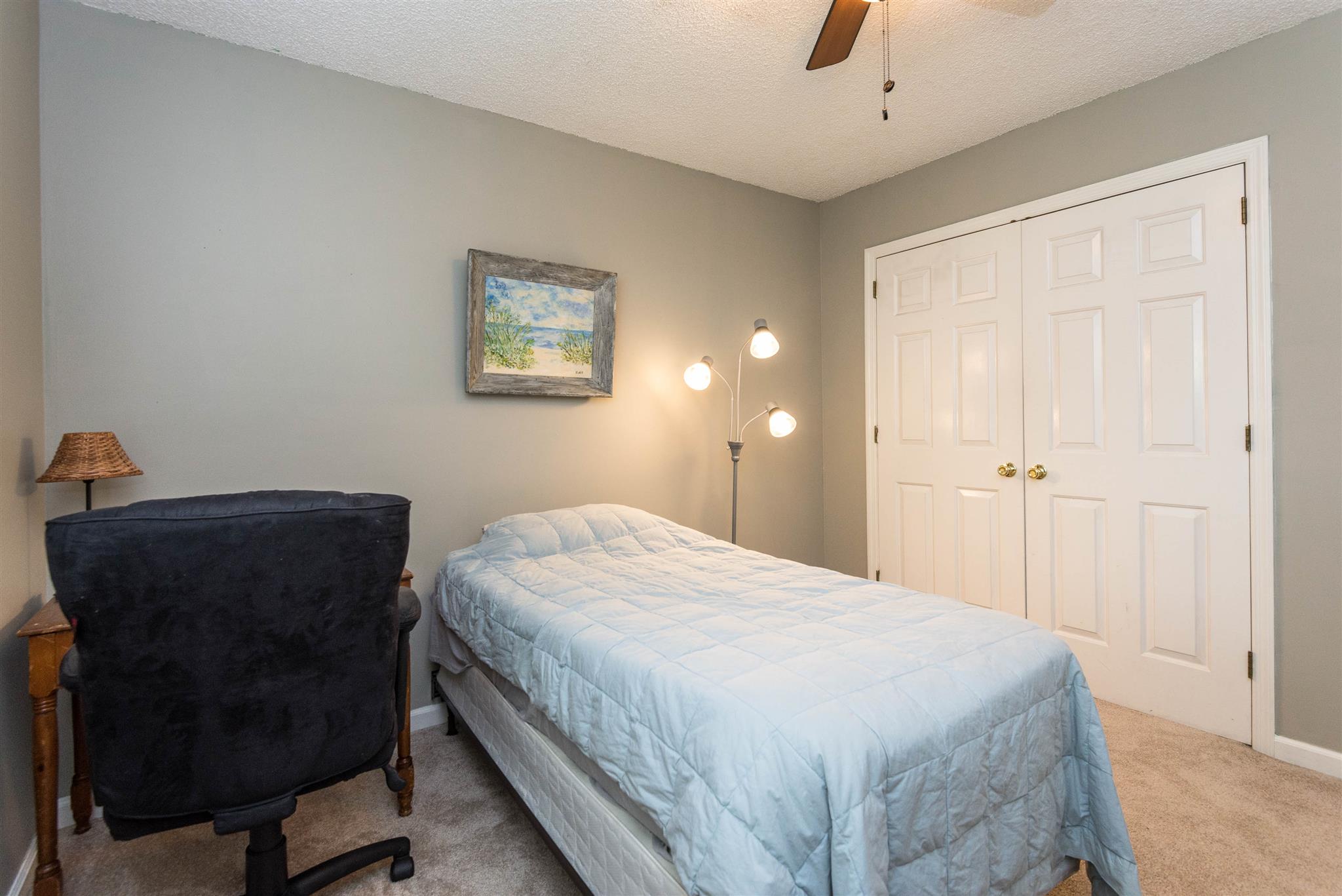 316 Cedarcliff Road Antioch, TN 37013 - Photo 23 of 27 a bedroom with a bed and a chair