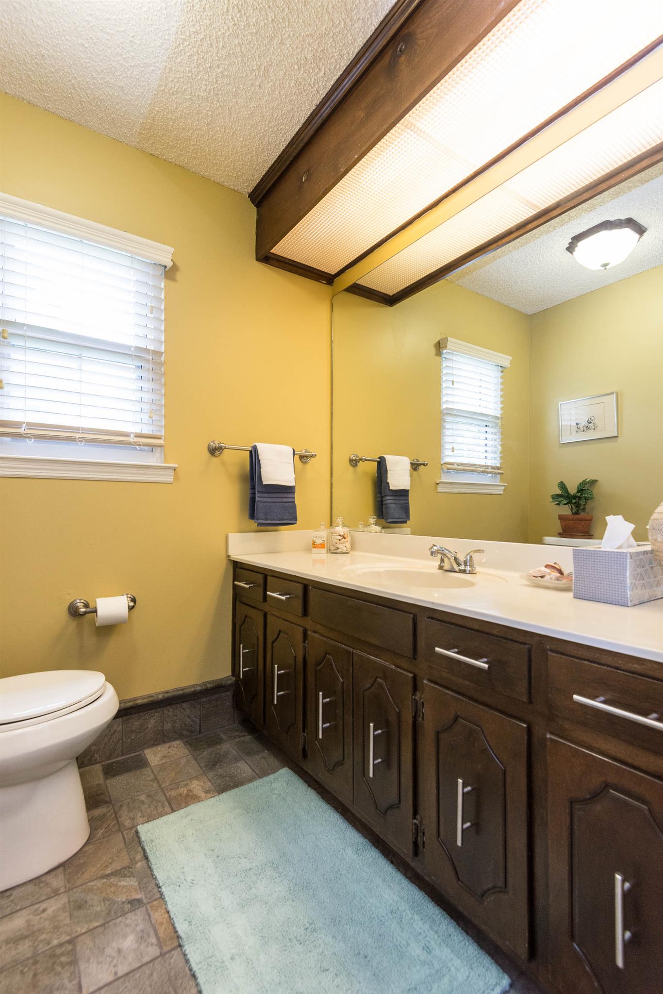 316 Cedarcliff Road Antioch, TN 37013 - Photo 24 of 27 a spacious bathroom with a double vanity sink toilet and a mirror