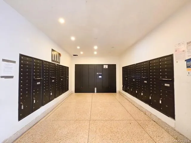 a view of an empty room with closet and a projector
