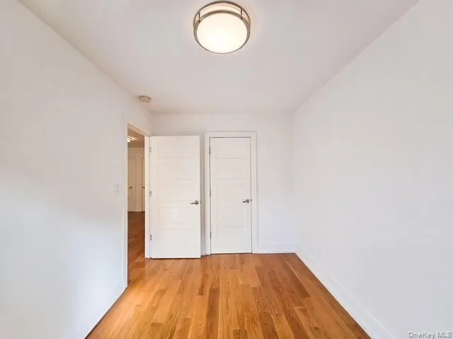a view of a room with wooden floor and glass door