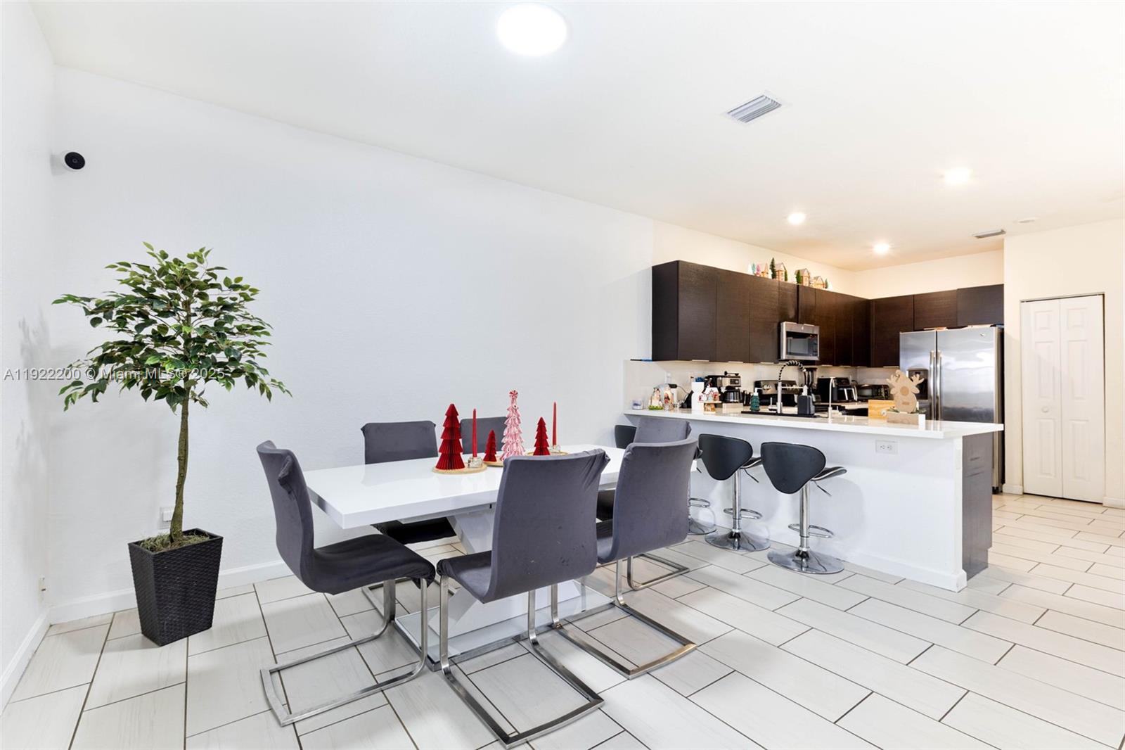 15070 Southwest 119TH Lane Miami, FL 33196 - Photo 6 of 30 a living room with furniture a flat screen tv and kitchen view