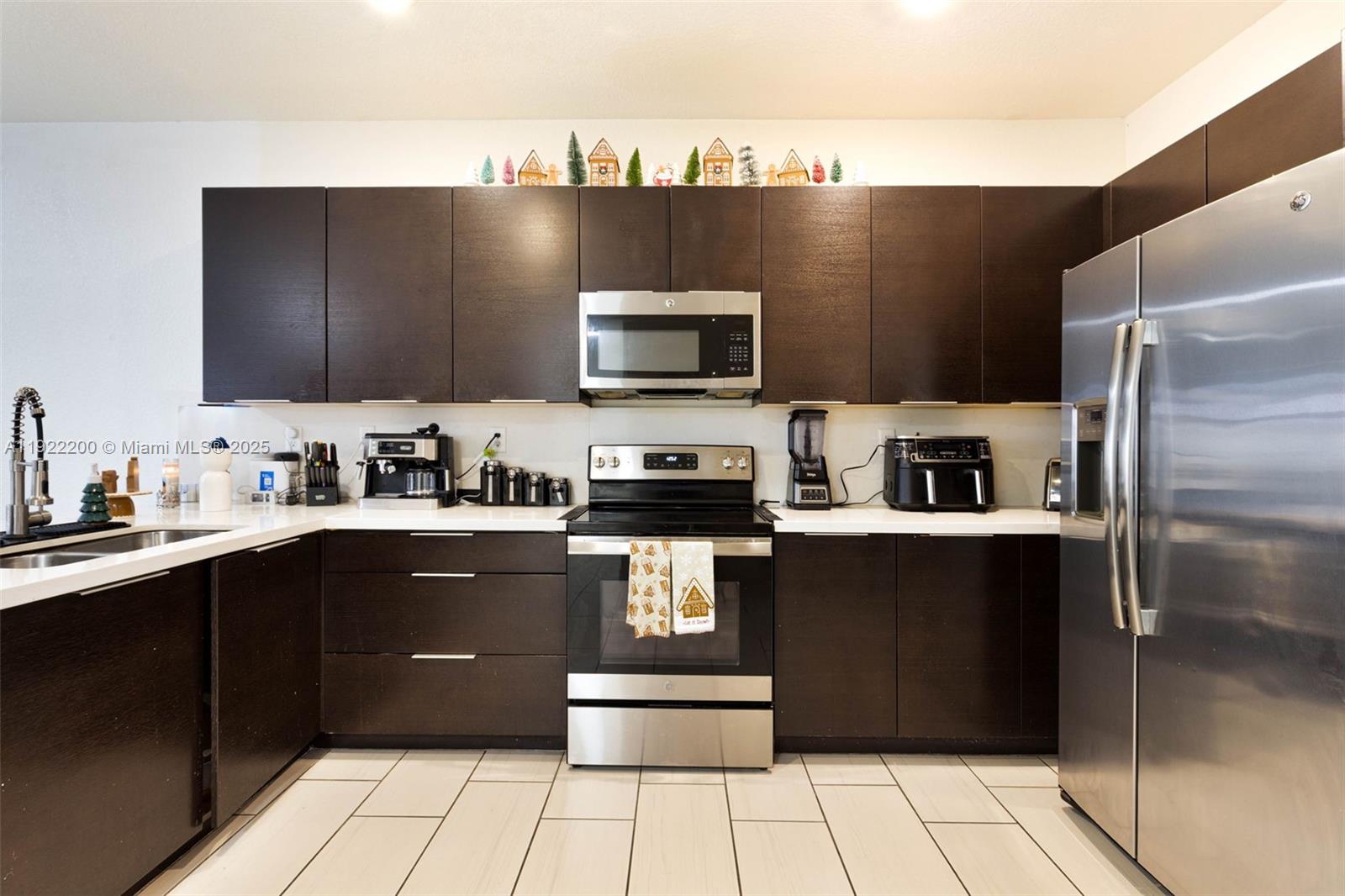 15070 Southwest 119TH Lane Miami, FL 33196 - Photo 8 of 30 a kitchen with a refrigerator and a sink