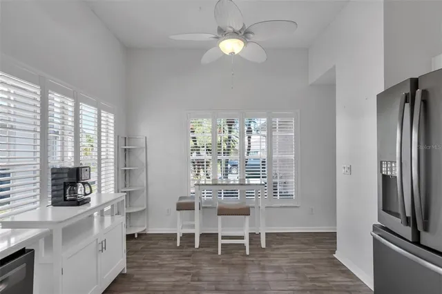 a bedroom with two beds and a ceiling fan