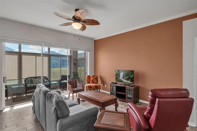 a view of a dining room with furniture a chandelier and wooden floor