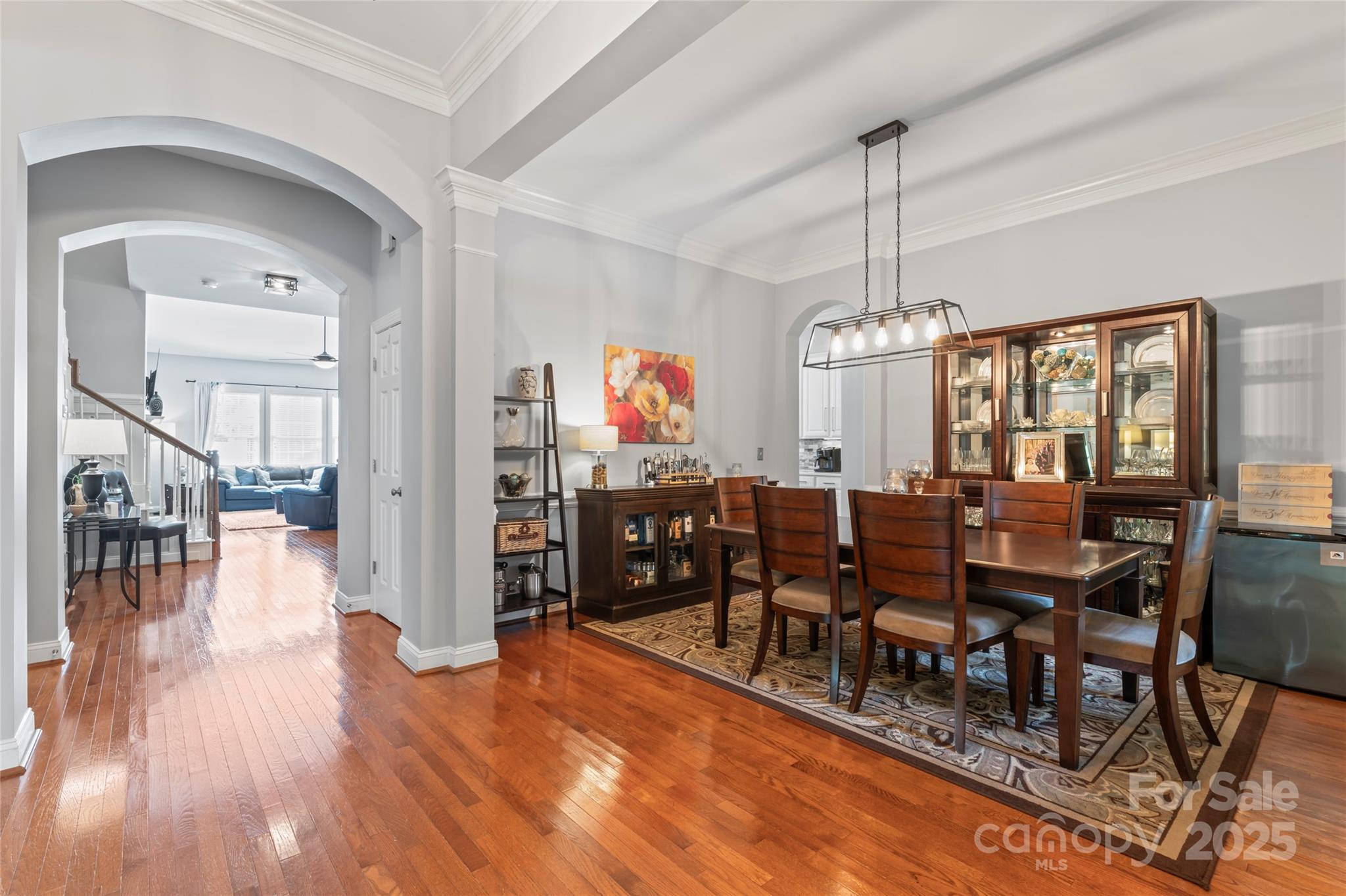 878 Promenade Walk Fort Mill, SC 29708 - Photo 16 of 48 a dining room with wooden floor a chandelier a wooden table and chairs