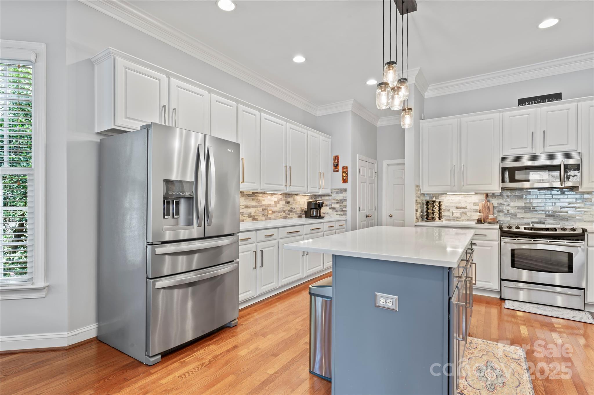878 Promenade Walk Fort Mill, SC 29708 - Photo 9 of 48 a kitchen with kitchen island granite countertop stainless steel appliances cabinets a sink and a center island