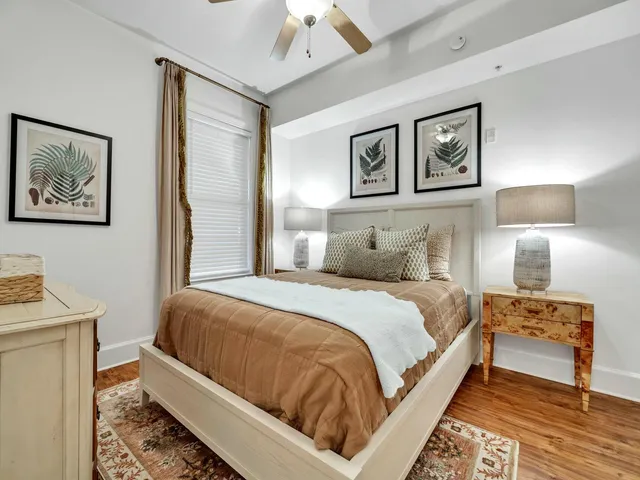 a bedroom with a bed and a painting on the wall