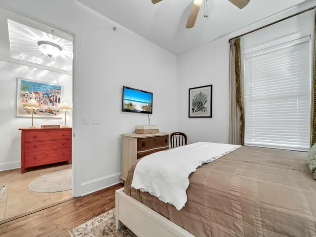 a bedroom with a bed and a painting on the wall