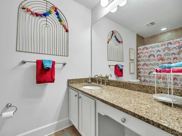 a kitchen with stainless steel appliances kitchen island granite countertop a refrigerator a stove sink and cabinets