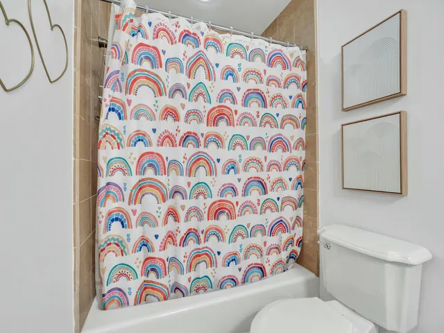 a living room with furniture a fireplace and a large window